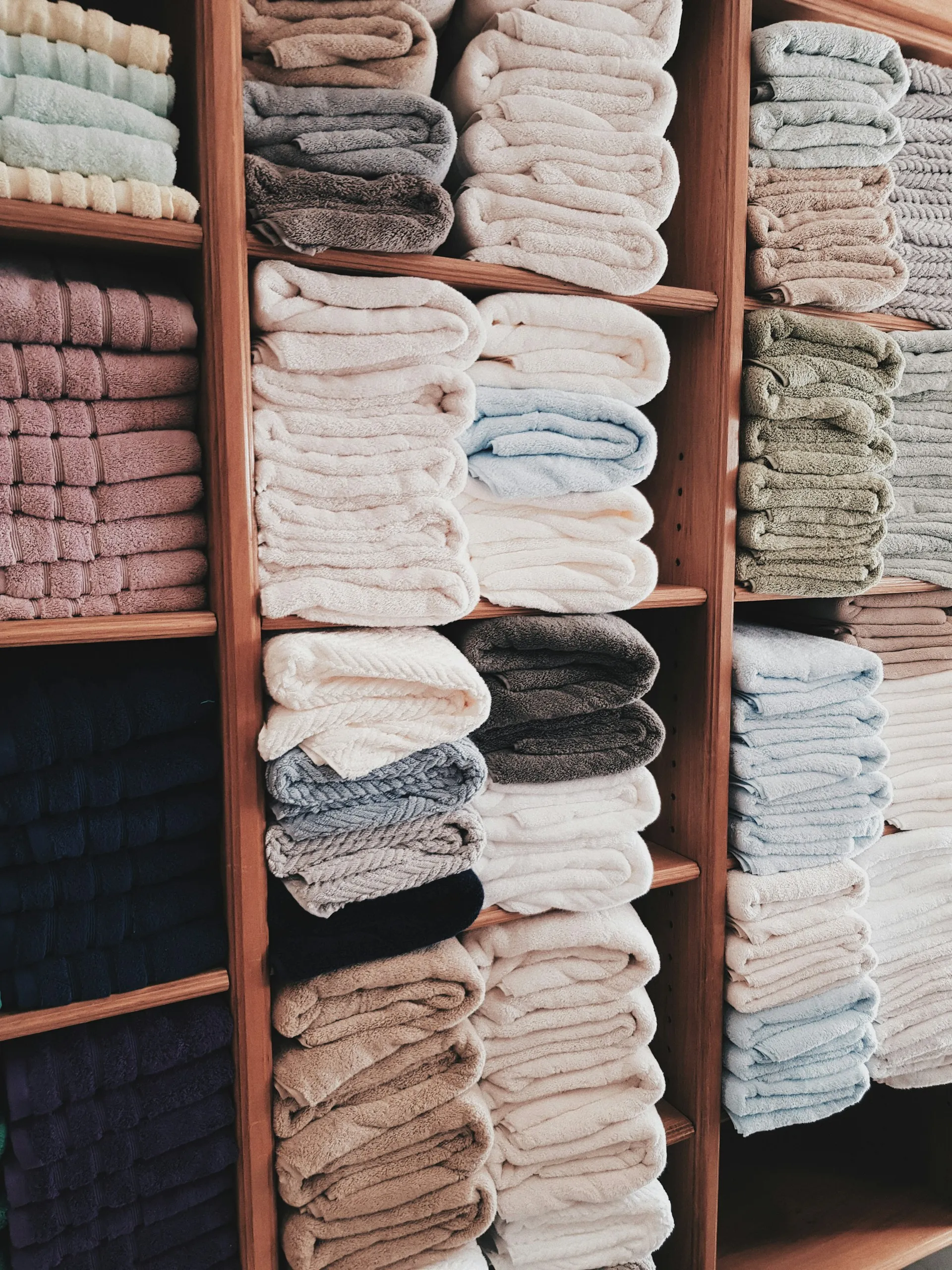 Neatly folded towels in a storage rack